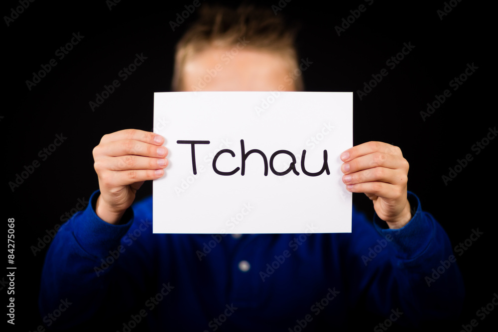 Child holding sign with Portuguese word Tchau - See You Later Child holding sign with Portuguese word Tchau - See You Later