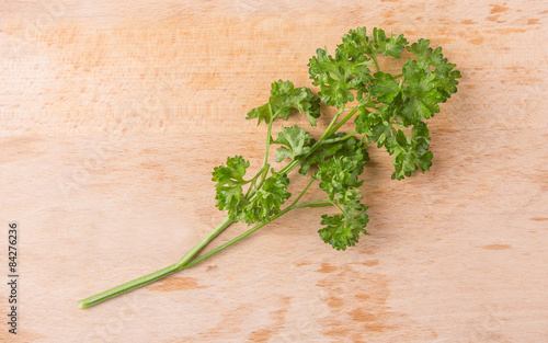 Parsley herbs leaves on wooden surface