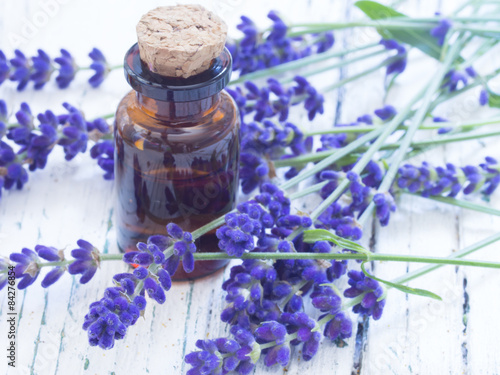 Fototapeta Naklejka Na Ścianę i Meble -  lavender oil with fresh flowers on the wooden table