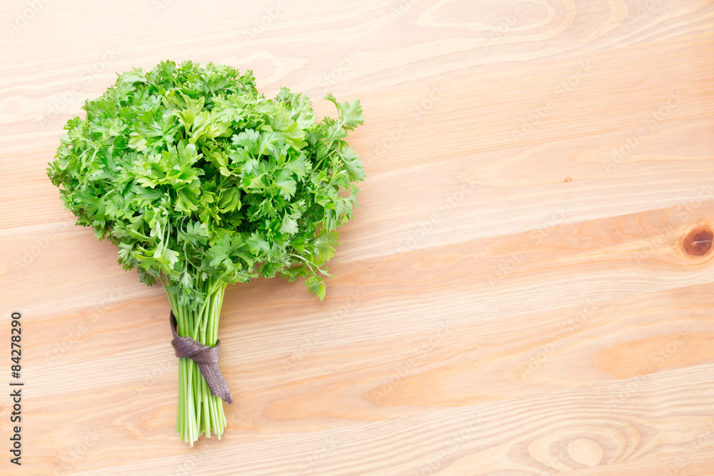 Fresh parsley on a light wooden background Fresh parsley on a light wooden background