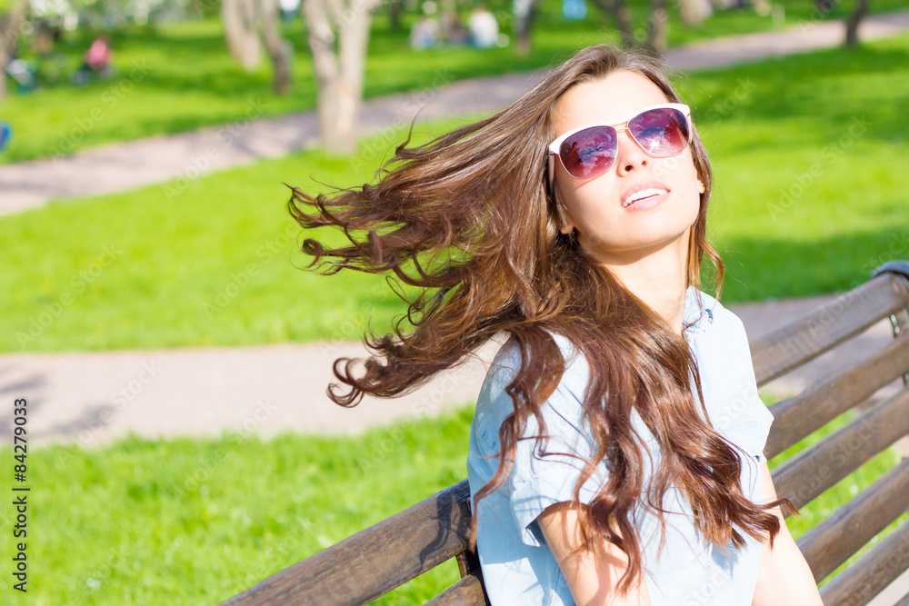 Summer portrait of laughing woman with sunglasses and streaming hair