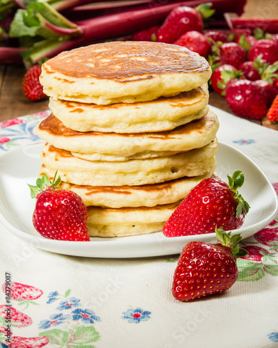 Pancakes with strawberries on plate