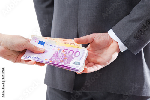 Businessman in a suit takes a bribe photo