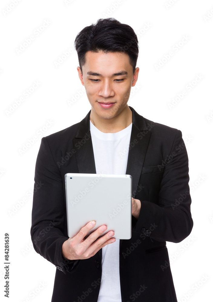 Asian young man use the digital tablet Asian young man use the digital tablet