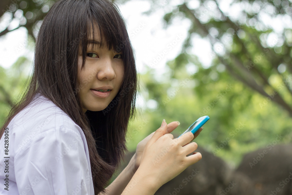 thai student teen beautiful girl using her smart phone thai student teen beautiful girl using her smart phone