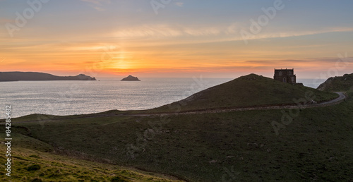 Sunset over Doyden Castle on coastline at Port Quin