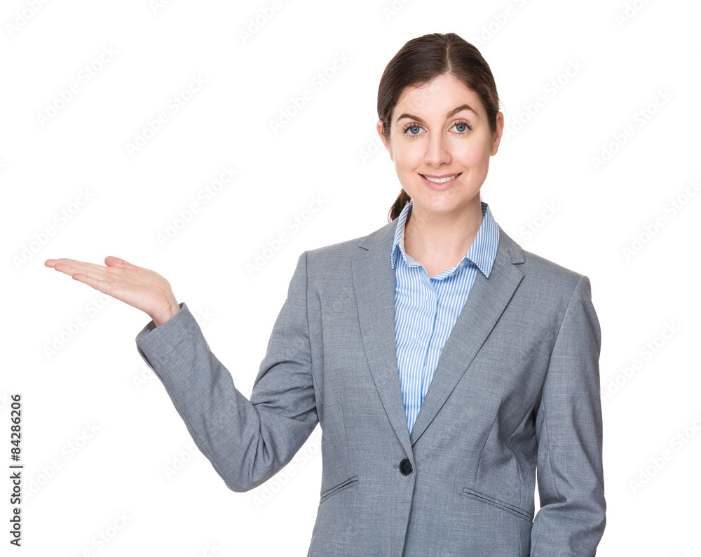 Brunette businesswoman with hand showing something Brunette businesswoman with hand showing something