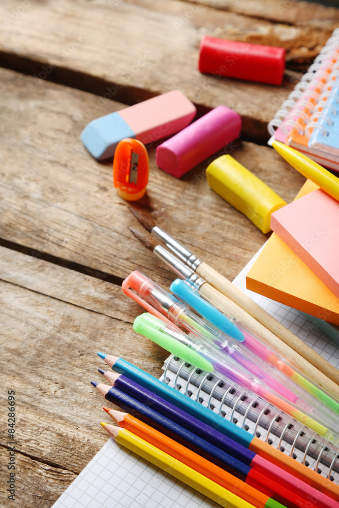 Bright school stationery on old wooden table Bright school stationery on old wooden table