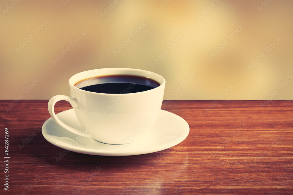 Cup of coffee on table on bright background Cup of coffee on table on bright background