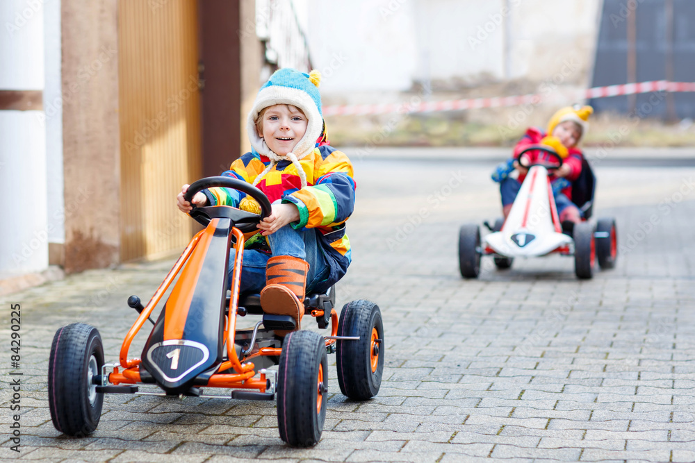 Two little kids boys having fun with toy race cars Two little kids boys having fun with toy race cars