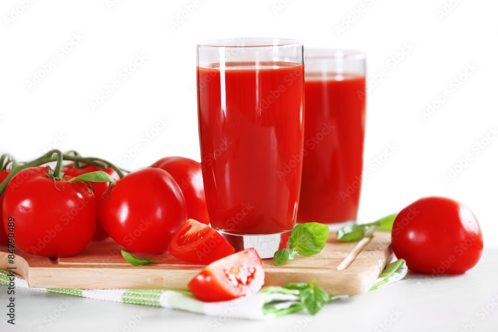 Tomato juice and fresh tomatoes on wooden table close-up Tomato juice and fresh tomatoes on wooden table close-up