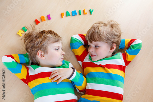 Two little sibling kid boys having fun together, indoors