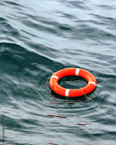 orange life buoy on the waves