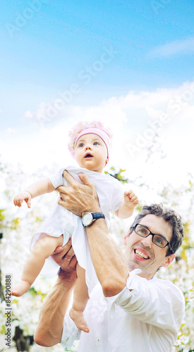 Cheerful father holding his lovely baby © konradbak