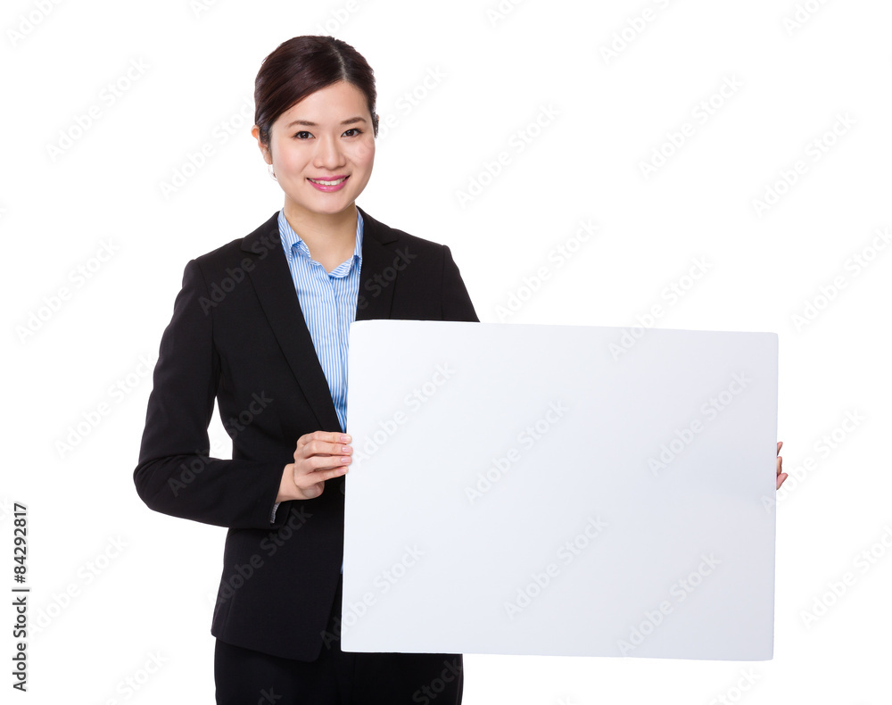 Young businesswoman showing with white poster Young businesswoman showing with white poster