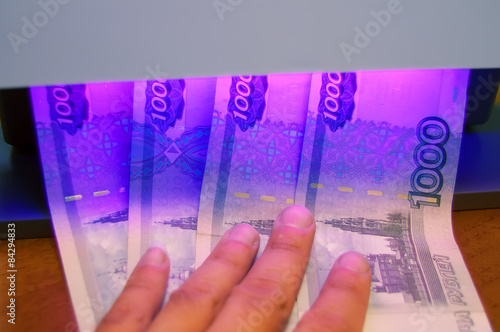 Fotografija Checking of banknotes using ultraviolet of detector