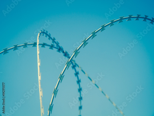 barbed wire on blue sky vintage background