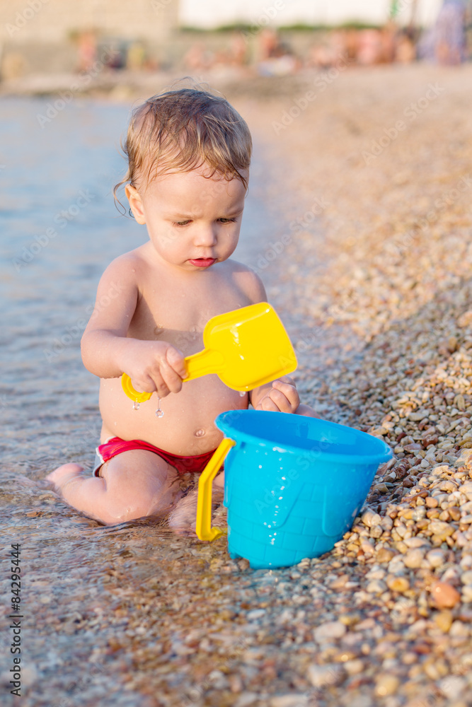 cute baby boy playing on the beach cute baby boy playing on the beach