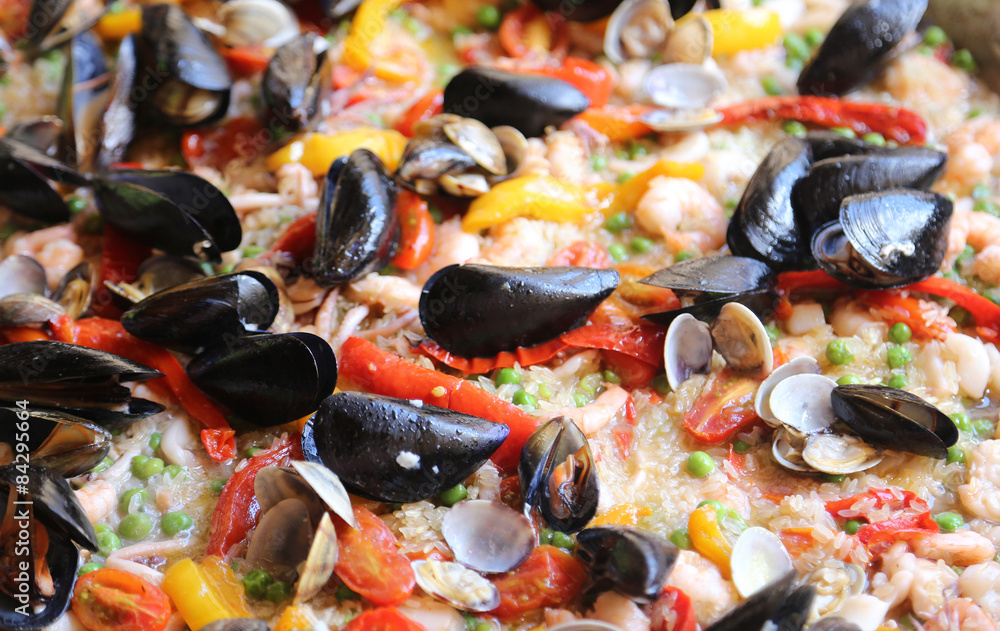 Fototapeta premium Valencian Paella rice with clams and mussels and paprika