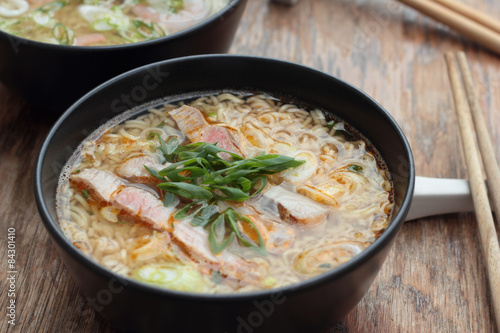 Bowl of oriental noodle and pork soup.