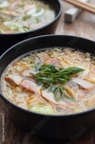 Bowl of oriental noodle and pork soup.