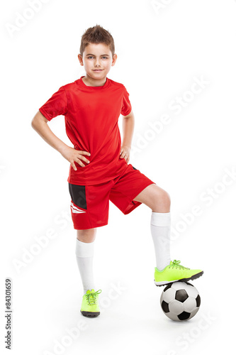 standing young soccer player with football