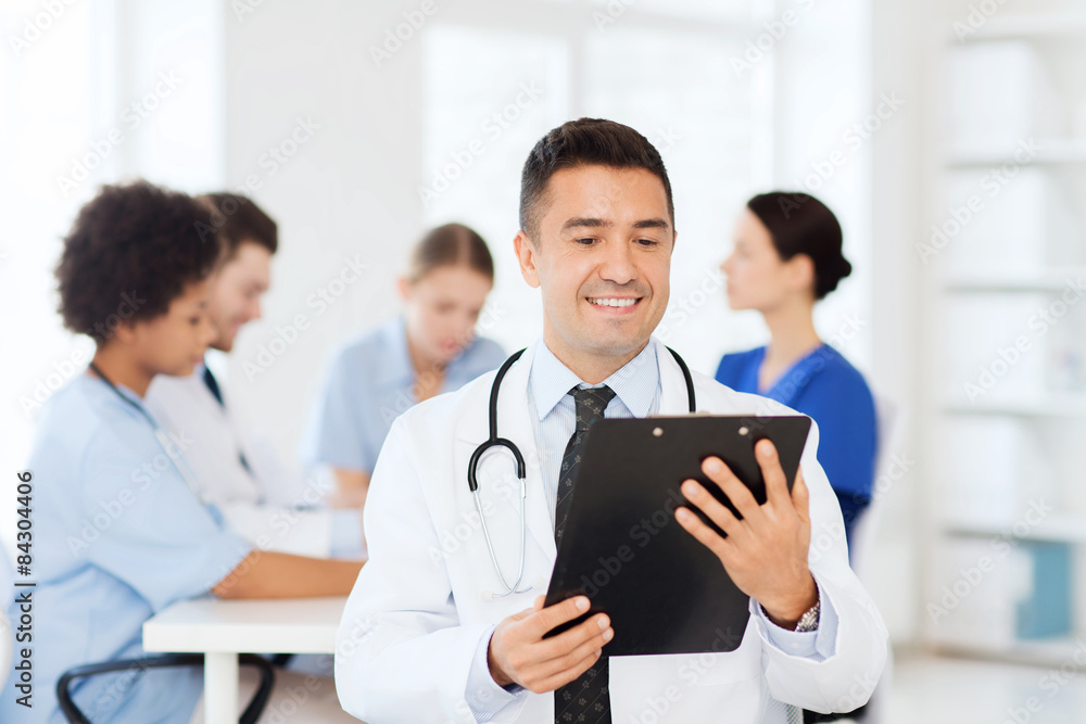 happy doctor with clipboard over medical team happy doctor with clipboard over medical team