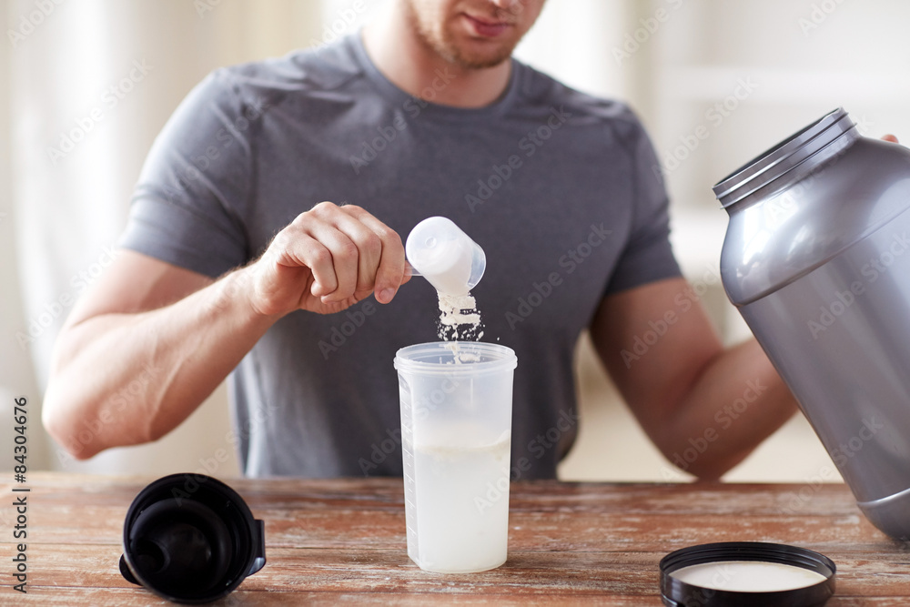 close up of man with protein shake bottle and jar - obrazy, fototapety, plakaty 