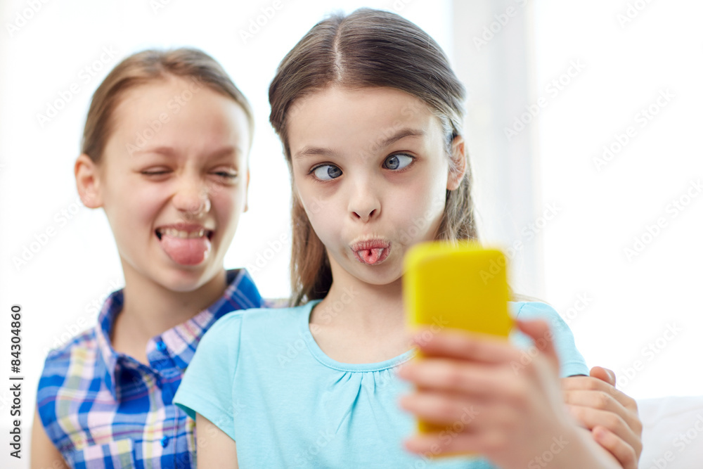 happy girls with smartphone taking selfie at home happy girls with smartphone taking selfie at home