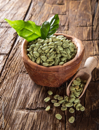 green coffee beans in wooden bowl