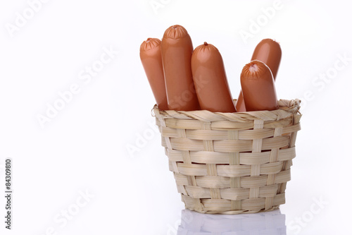 Appetizing sausages in basket photo