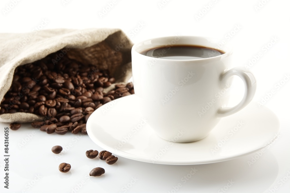 Cup of coffee with saucer with bag with coffee beans on white Cup of coffee with saucer with bag with coffee beans on white