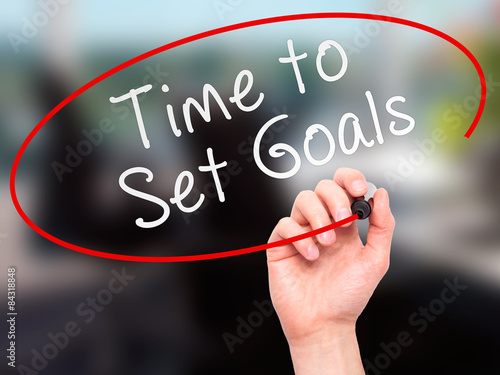 Man hand writing Time to Set Goals on visual screen