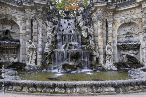 Fountain with faunus statues and streaming water at Zwinger pala