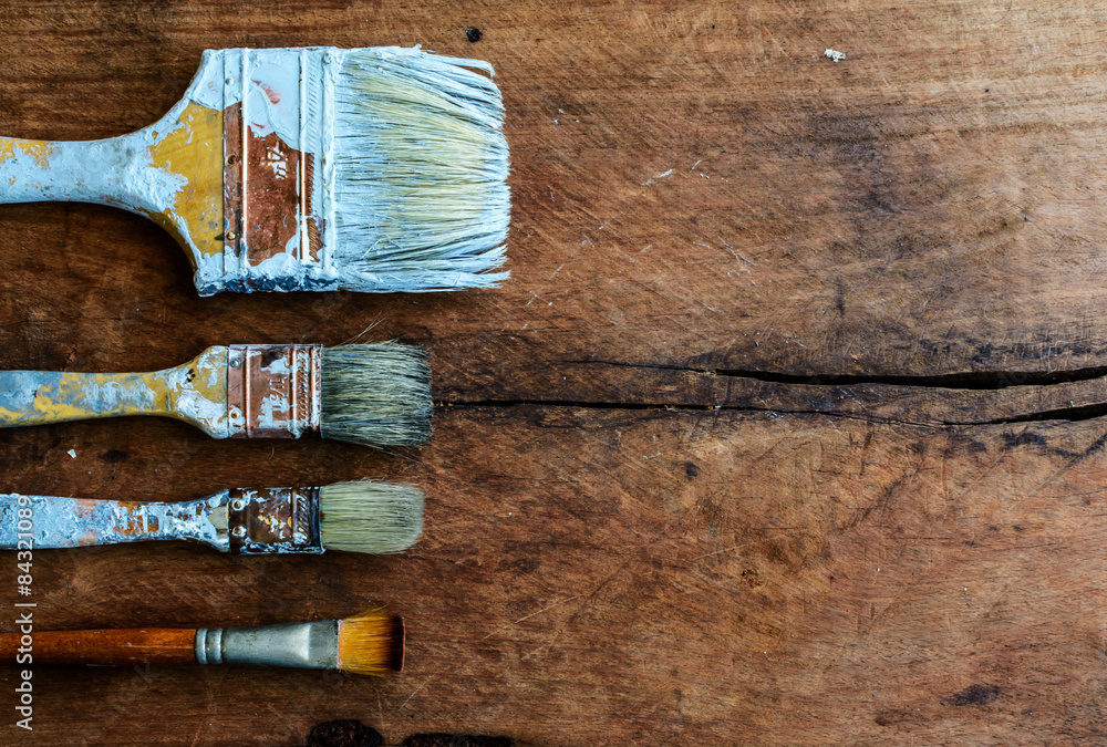 grunge paintbrush on old wood background with copy space
