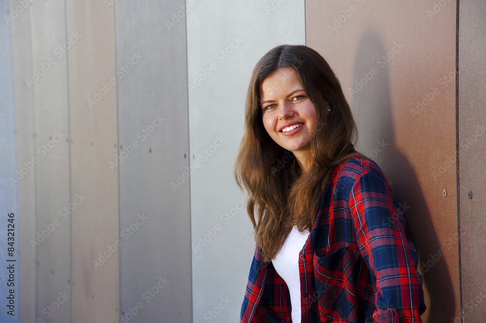 Girl city portrait. Woman smiling outside in evening light by th Girl city portrait. Woman smiling outside in evening light by th