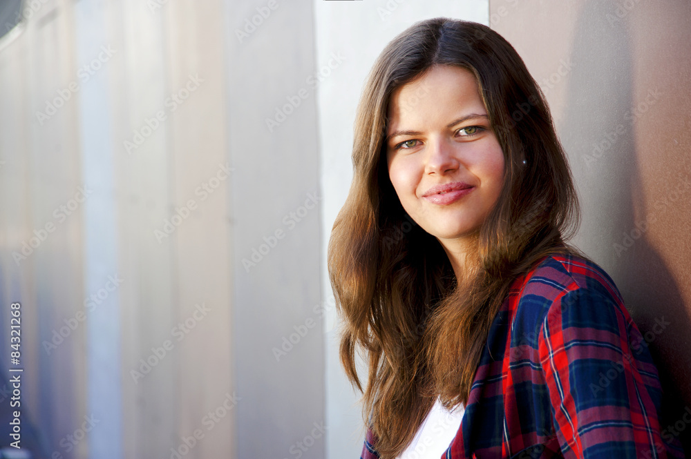 Girl city portrait. Woman smiling outside in evening light by th Girl city portrait. Woman smiling outside in evening light by th