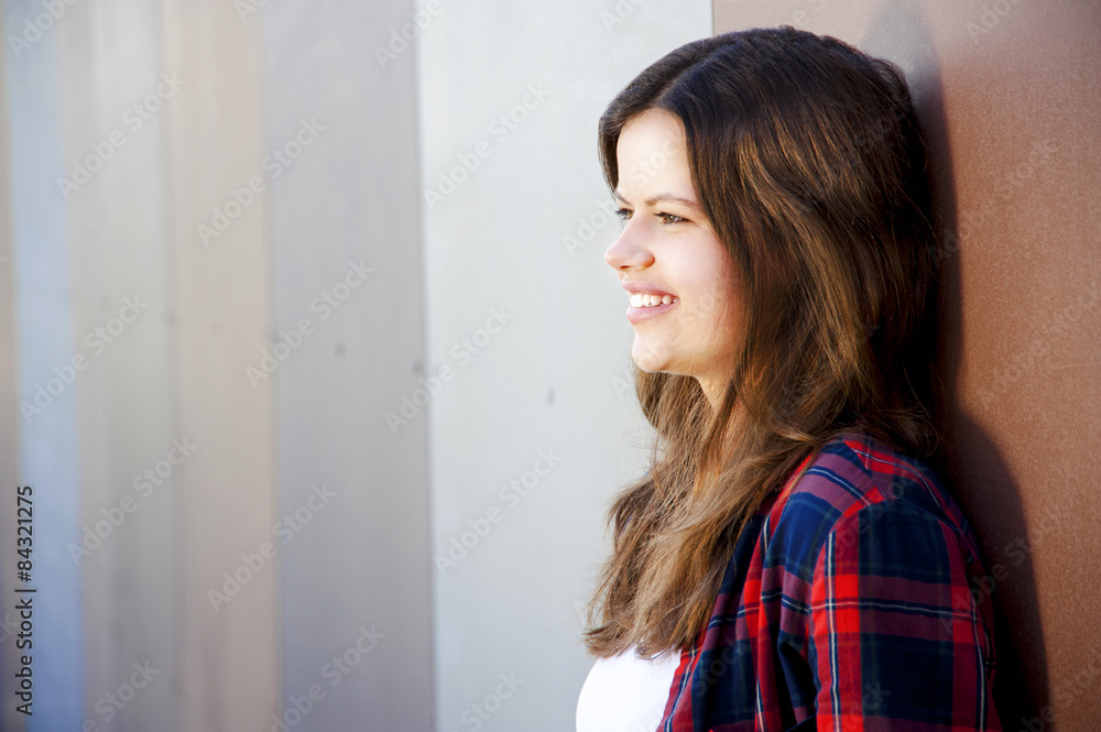 Girl city portrait. Woman smiling outside in evening light by th Girl city portrait. Woman smiling outside in evening light by th