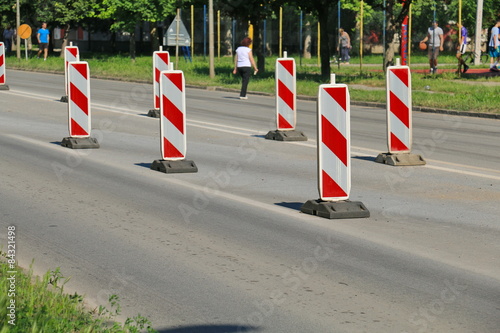 Road works marked with red and white striped road warning posts  © Željko Radojko
