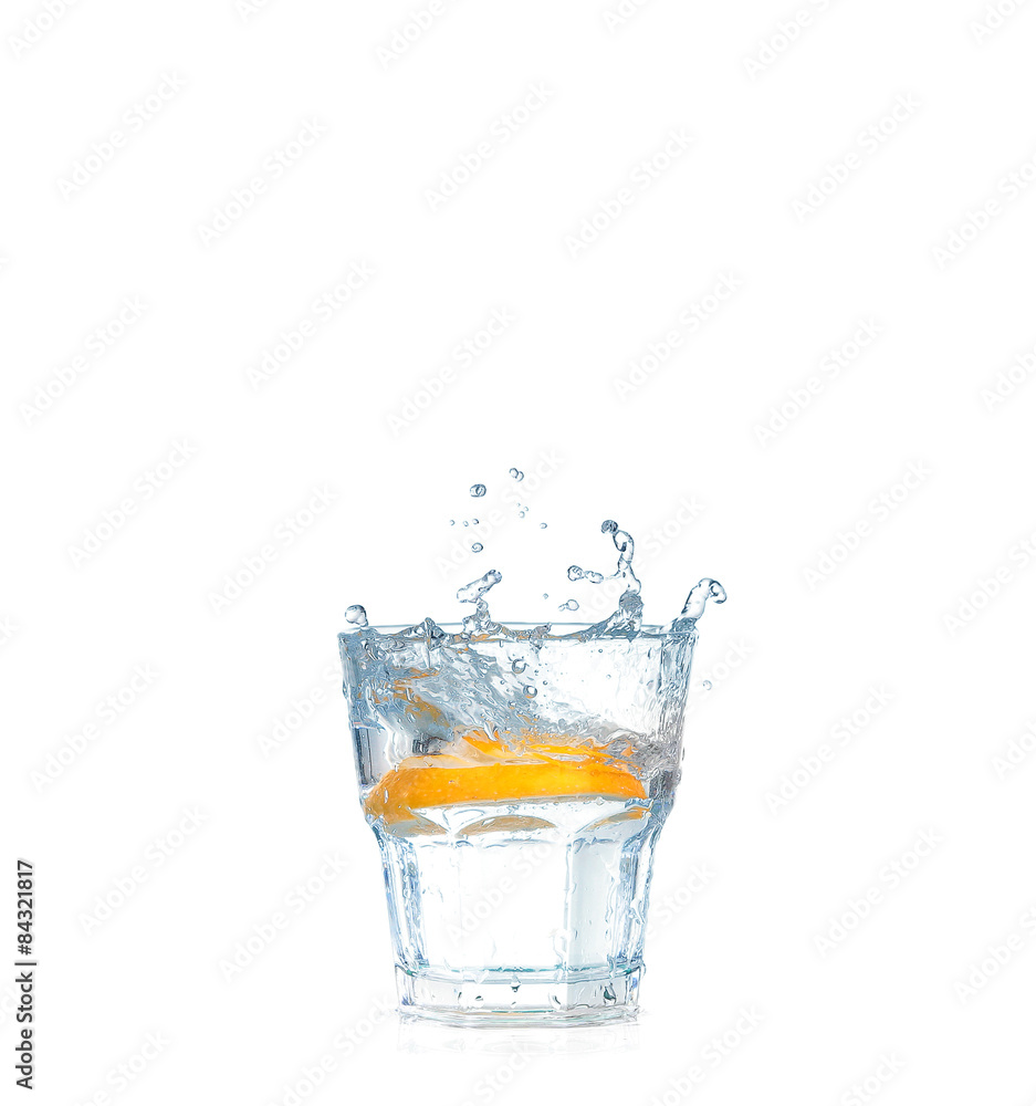 Ice cubes splashing into glass of water, isolated on white Ice cubes splashing into glass of water, isolated on white