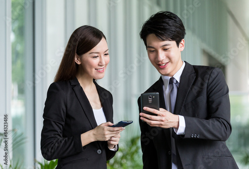 Photography Business partner discuss about the detail on smartphone