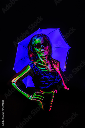 Skeleton bodyart with blacklight studio portrait