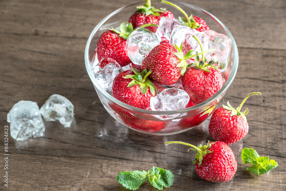 Fresh strawberries with ice cubes in the glass bowl Fresh strawberries with ice cubes in the glass bowl