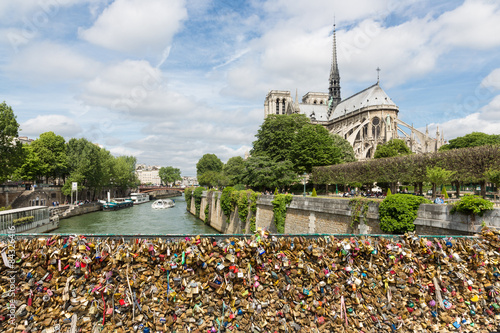 Love padlocks at bridge over river Seine in Paris, France