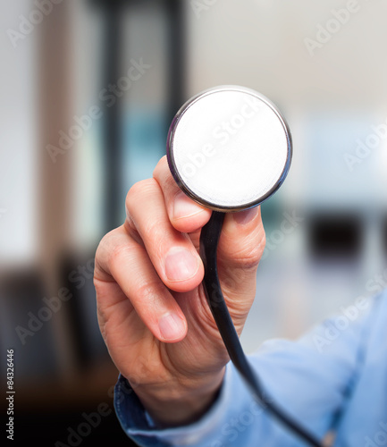 Male doctor working with stethoscope in his hand.