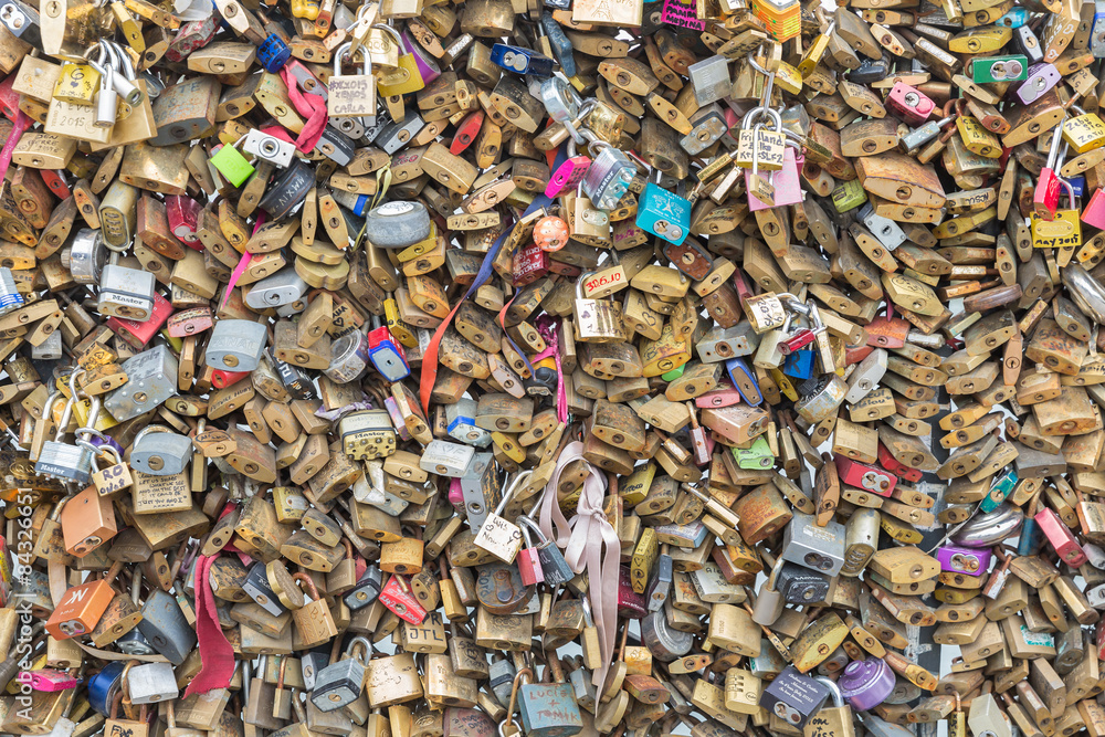 Love padlocks at bridge over river Seine in Paris, France Love padlocks at bridge over river Seine in Paris, France