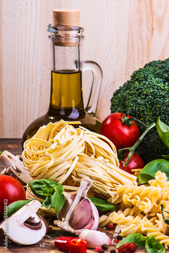 Pasta ingredients on a wood background 