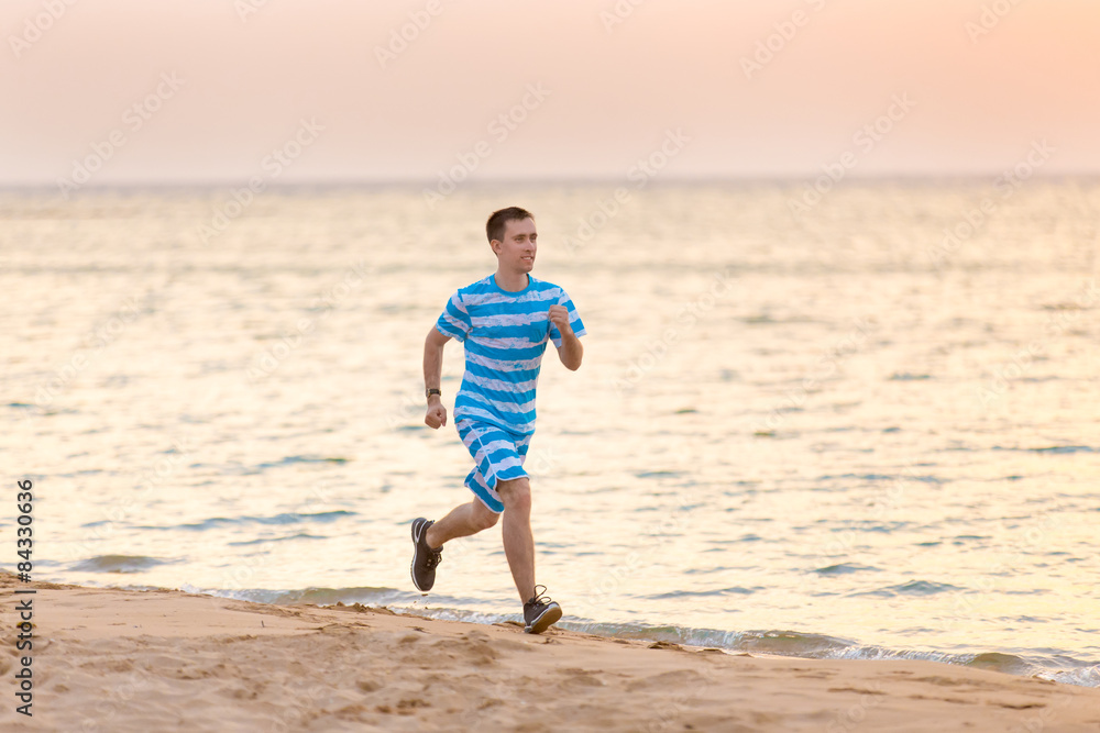 Young man jogging at the sea shore