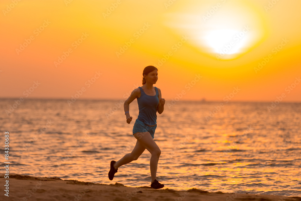 Young woman jogging at sunrise