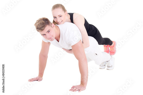 young muscular man doing push ups with beautiful woman on back i